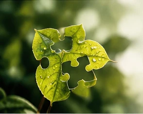 A green leaf made of interlocking puzzle pieces